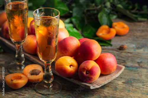 Fresh apricots and glasses apricot liquor.