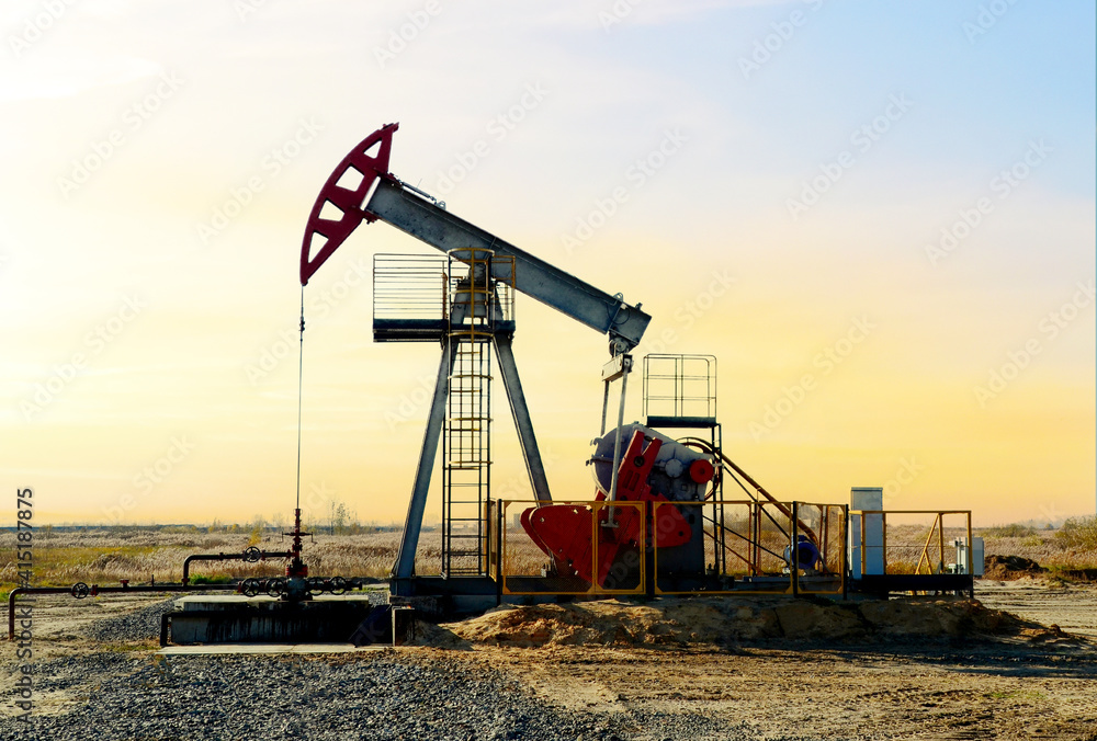 Crude oil pump jack at oilfield on atmospheric sunset backround. Fossil crude output and fuels oil production. Oil drill rig and drilling derrick. Global crude oil Prices, energy, petroleum demand Crude oil pump jack at oilfield on atmospheric sunset backround. Fossil crude output and fuels oil production. Oil drill rig and drilling derrick. Global crude oil Prices, energy, petroleum demand