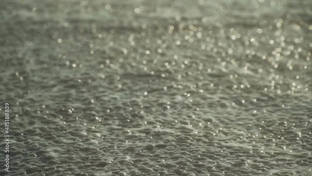 Small wave, Soft wave on sand beach for opening video, text space. High Tide and Low tide Ocean Wave On black sandy beach. Small wave, Soft wave on sand beach for opening video, text space. High Tide and Low tide Ocean Wave On black sandy beach.