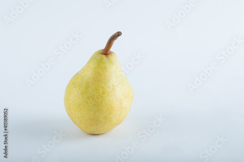 Yellow, juicy, ripe pear on a white background.