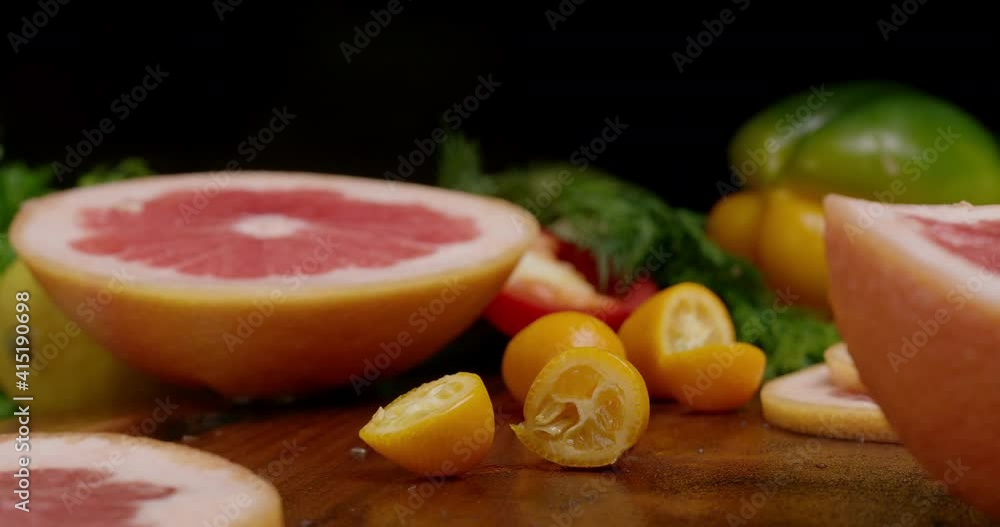 The motion of slicing fruits for preparing fruits salad. Chopping kumquat to make a cocktail. The motion of slicing fruits for preparing fruits salad. Chopping kumquat to make a cocktail.