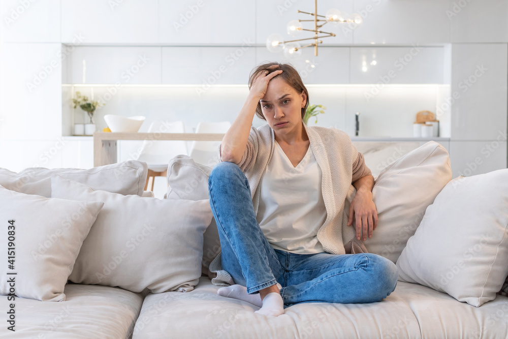 Obraz premium Tired woman sitting on the couch