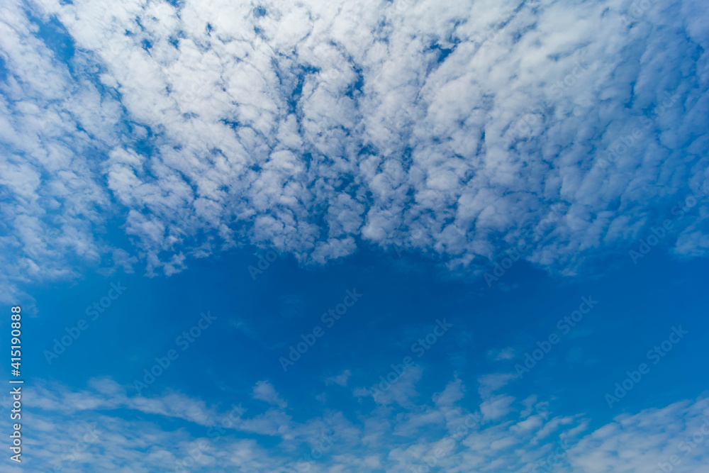 Beautiful white clouds covering thinly spread the sky on the blue of the sky background.