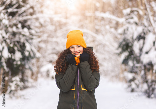 Portrait of a beautiful young girl in winter in nature
