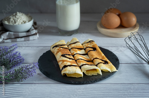 Sweet crepes with fresh red berries and chocolate