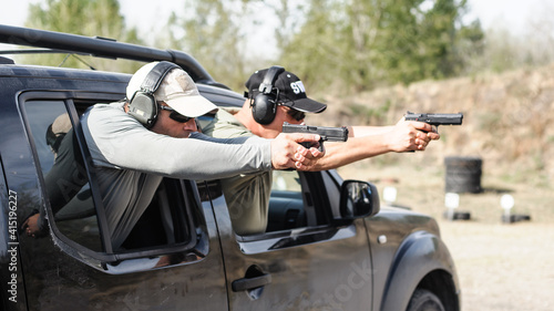 Military tactical car shooting. Army soldiers in action. Outdoor shooting range