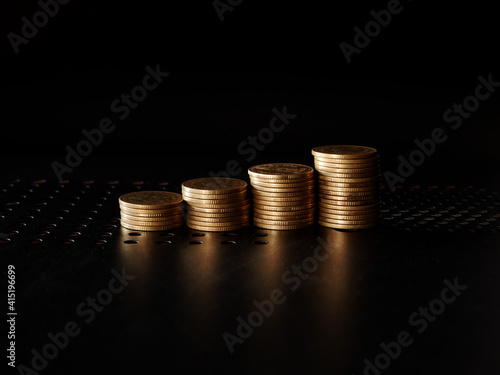Wallpaper Mural stacks of gold coin on black background concept saving money Torontodigital.ca