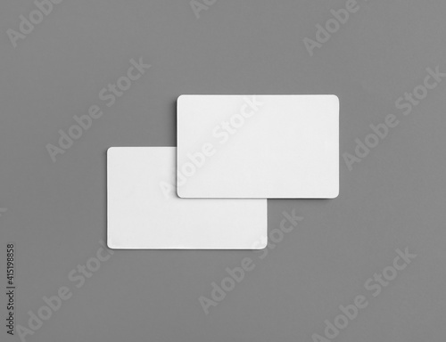 Photo of two blank business cards on gray background. Branding ID template. Flat lay.