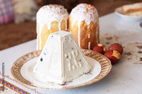 Orthodox Easter. Easter cakes, Easter Ortodox curd cake and colored eggs on table. Side view