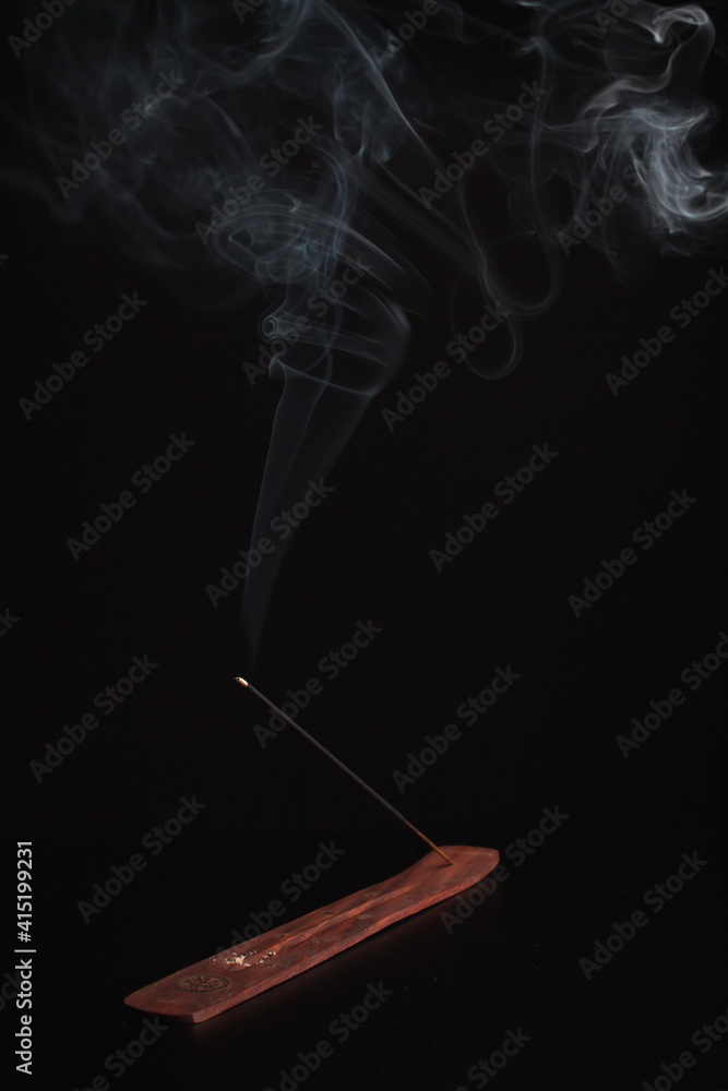 Incense burning giving of different patterns of smoke Incense burning giving of different patterns of smoke