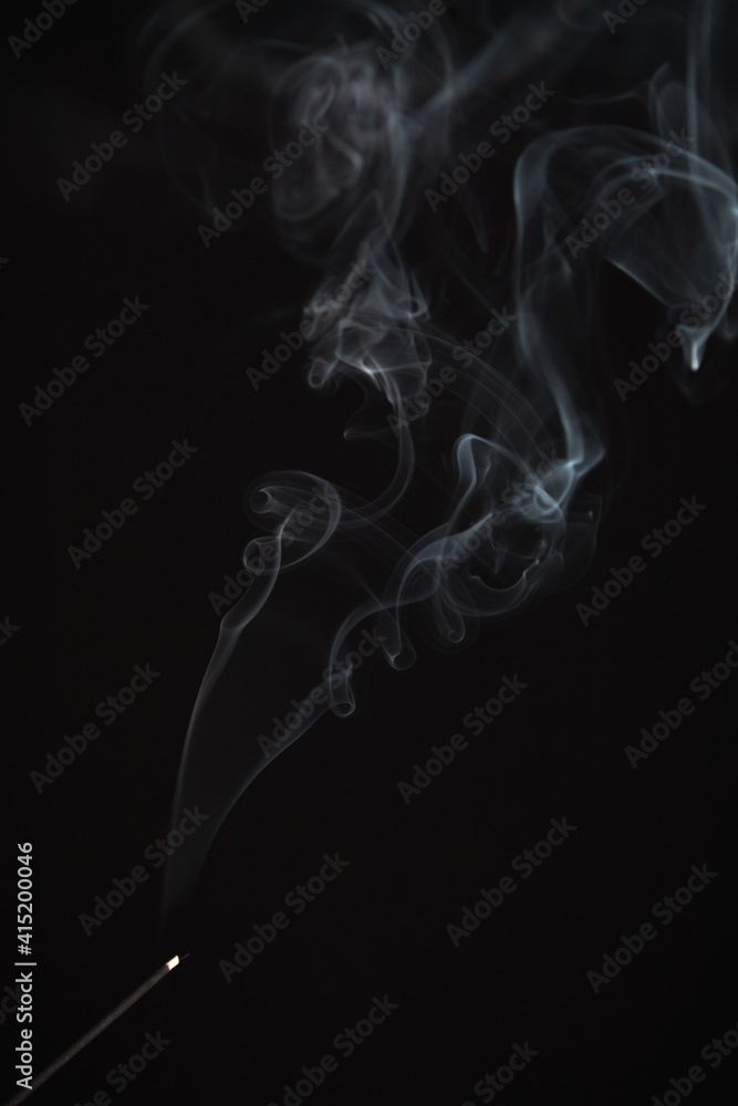 Incense burning giving of different patterns of smoke Incense burning giving of different patterns of smoke