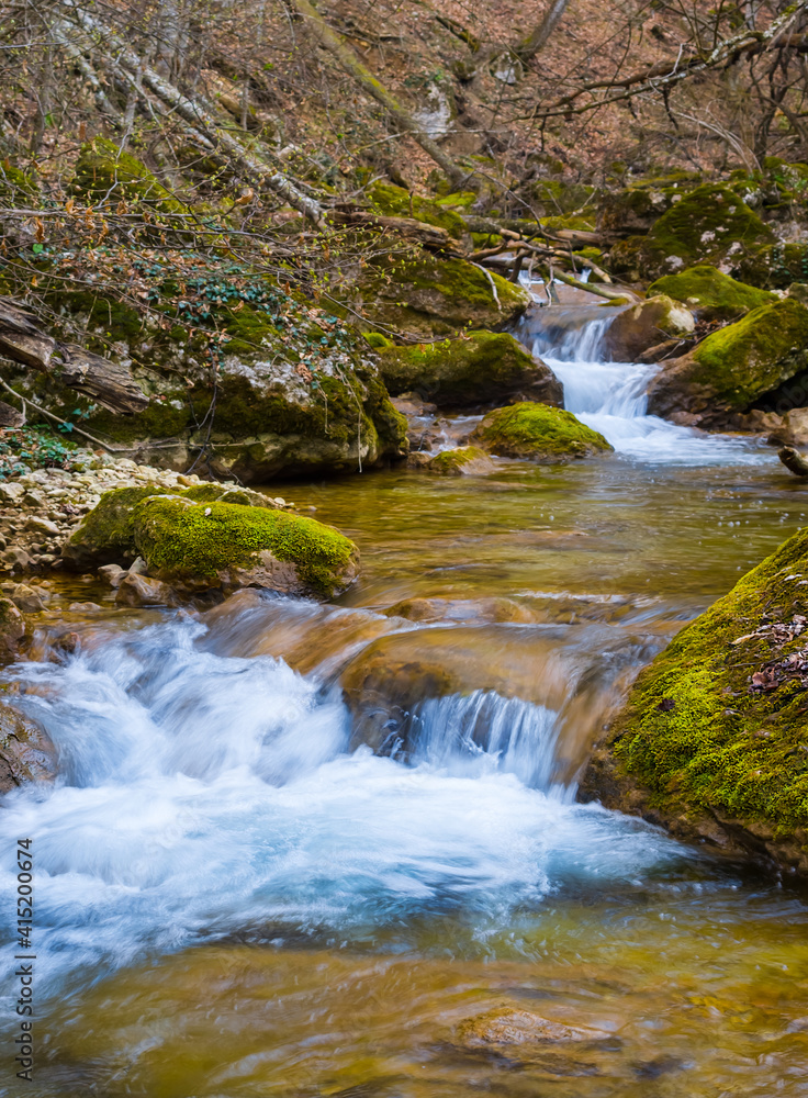 small river rushing through the mountain canyon, spring outdoor scene small river rushing through the mountain canyon, spring outdoor scene