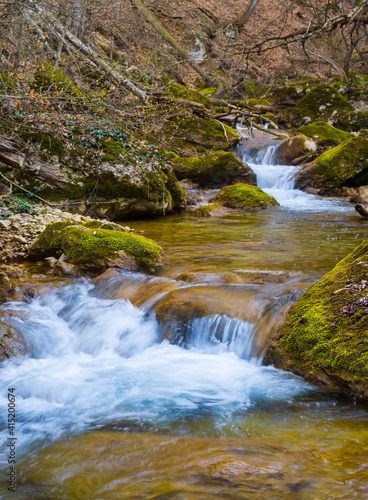 small river rushing through the mountain canyon, spring outdoor scene