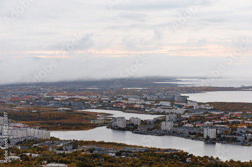 Autumn Panoramic view of the northern city of Monchegorsk, located among the mountains, taiga forest and many lakes. Orthodox Cathedral in the foreground. Kola Peninsula, Russia © dron285