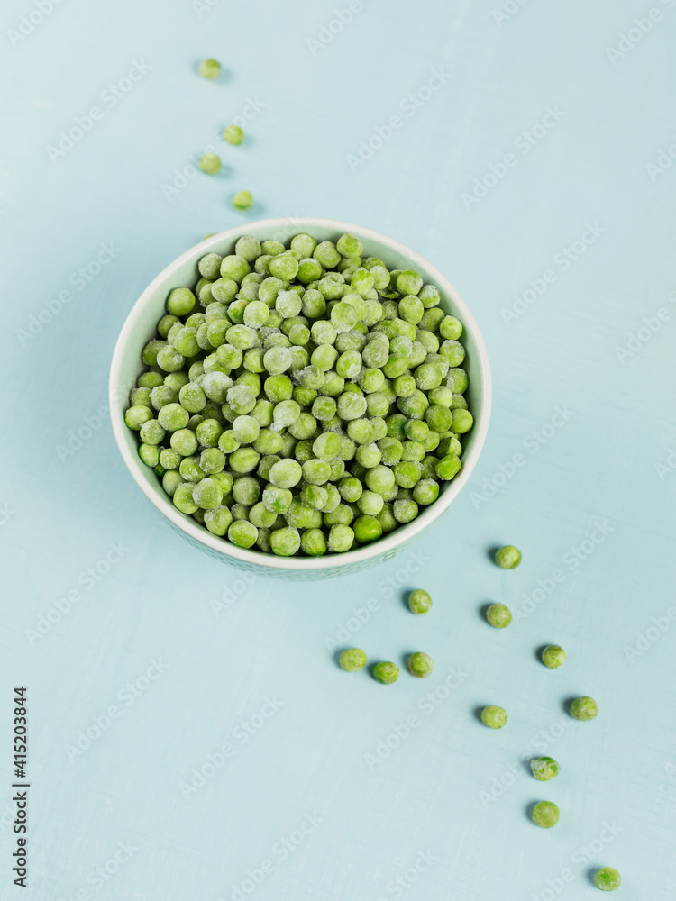 Green organic peas in a bowl. Concept of homemade preparations for fast cooking Green organic peas in a bowl. Concept of homemade preparations for fast cooking