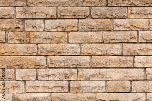 Beige stone wall close up.