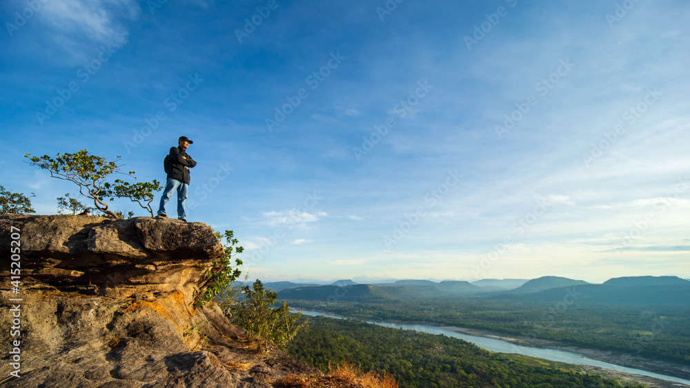The atmosphere, sky, clouds over the mountains, and the Mekong River at Cha Na Dai Cliff, Ubon Ratchathani, Thailand.