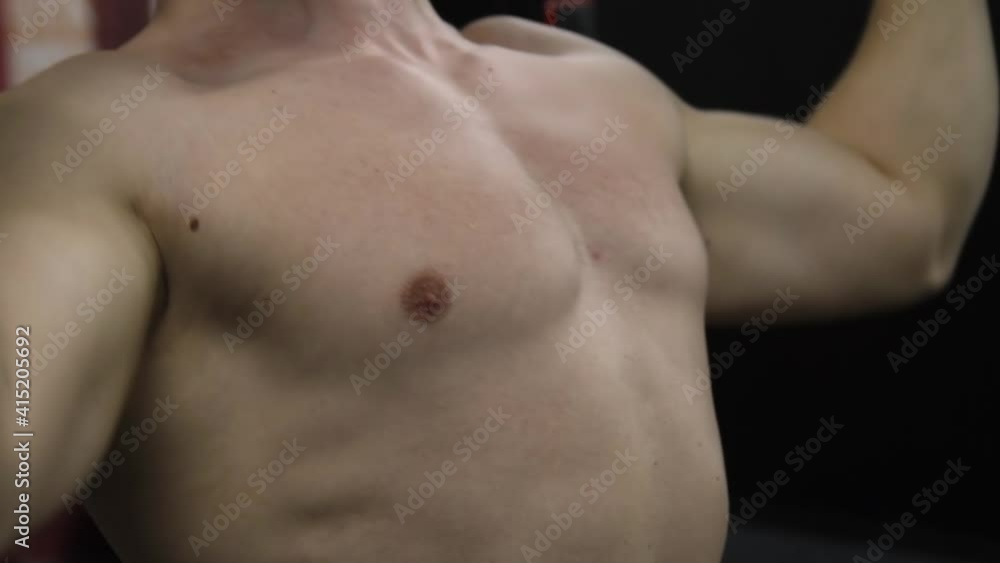 Fitness man pumping up arm muscles. Fitness workout and bodybuilding healthy concept background. Bodybuilder doing arms exercises in gym naked torso. Handsome power athletic man in trainin Fitness man pumping up arm muscles. Fitness workout and bodybuilding healthy concept background. Bodybuilder doing arms exercises in gym naked torso. Handsome power athletic man in trainin