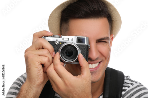 Man with straw hat taking picture on white background, closeup. Summer travel