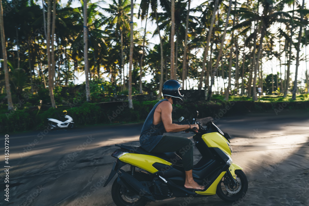 Man riding scooter on beach Man riding scooter on beach