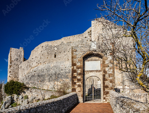 The small medieval village of Castel San Pietro Romano, Lazio, province of Rome, Palestrina. The ancient entrance to the castle with the bridge and gate. The impressive stone defensive walls.