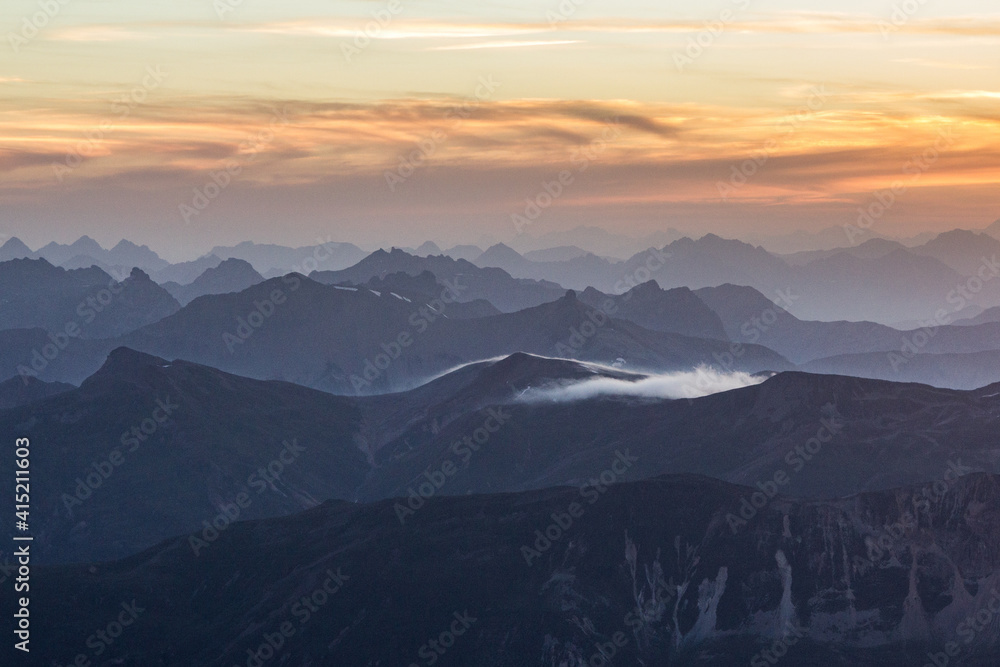 misty mountain ranges in a golden sunrise in the swiss alps misty mountain ranges in a golden sunrise in the swiss alps