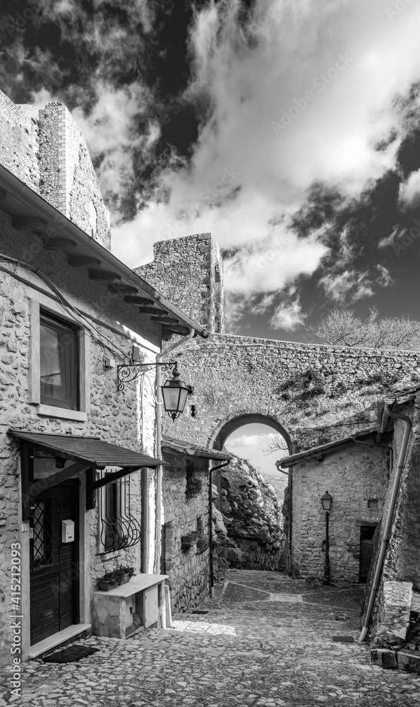 February 12, 2021 - Castel San Pietro Romano, Lazio, Rome, Palestrina - A glimpse of the medieval village, with the cobbled alley between the houses. The arch formed by the stone bridge of the castle.