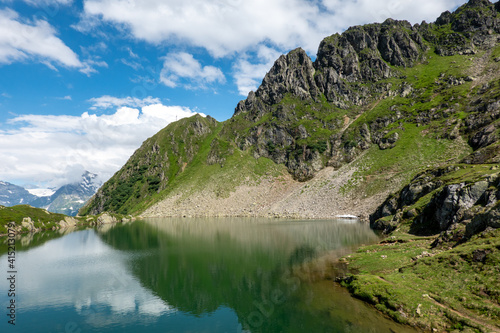 mountain lake blue sky with clouds reflection