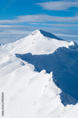 zigzagging snow covered ridgeline in the swiss alps
