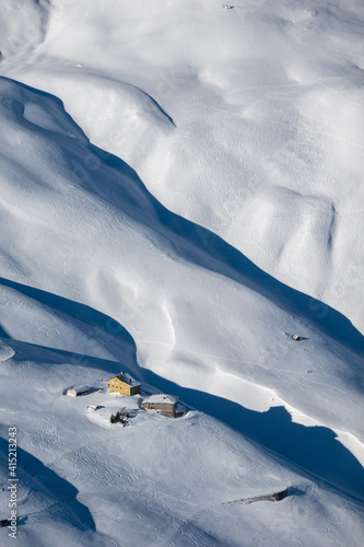 snowy slopes with ski trails and hotel