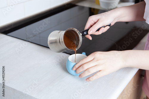 girl preparing coffee in the kitchen