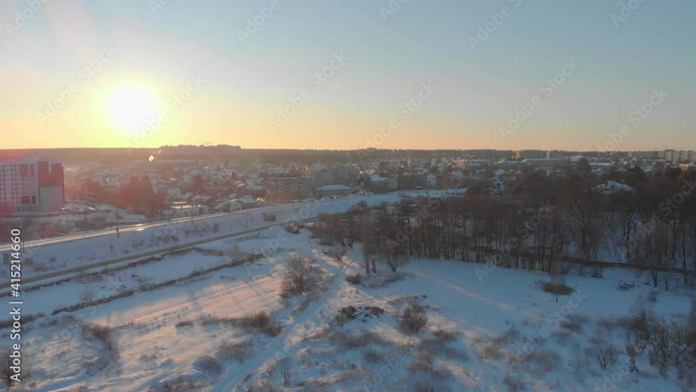 Sunset aerial cityscape winter snow drone view Irpin Ukraine landing down camera movement Sunset aerial cityscape winter snow drone view Irpin Ukraine landing down camera movement