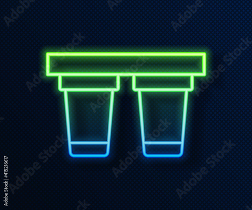 Glowing neon line Water filter icon isolated on blue background. System for filtration of water. Reverse osmosis system. Vector.