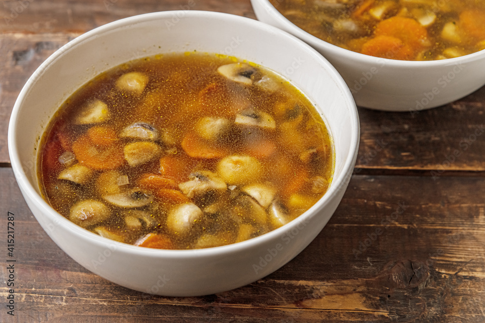 homemade champignon soup in a ceramic bowls on a wooden table homemade champignon soup in a ceramic bowls on a wooden table