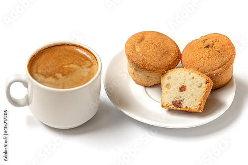 homemade mini cupcakes with raisins on a white plate and a cup of coffee on a white surface