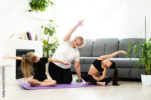 grandmother and children exercising workout at home near the window in room