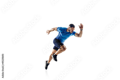 In air. Caucasian professional male athlete, runner training isolated on white studio background. Muscular, sportive man. Concept of action, motion, youth, healthy lifestyle. Copyspace for ad. © master1305