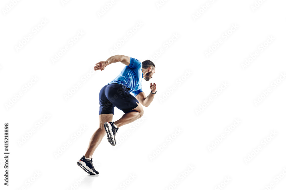 In jump. Caucasian professional male athlete, runner training isolated on white studio background. Muscular, sportive man. Concept of action, motion, youth, healthy lifestyle. Copyspace for ad.