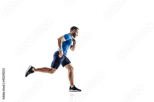 Purpose. Caucasian professional male athlete  runner training isolated on white studio background. Muscular  sportive man. Concept of action  motion  youth  healthy lifestyle. Copyspace for ad.