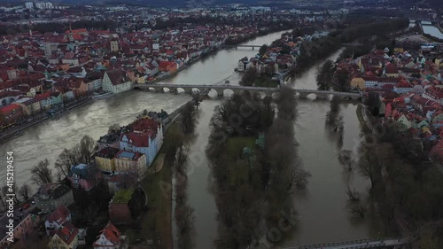 Filmmaterial einer Luftaufnahme mit einer Drohne der Altstadt Regensburg während Hochwasser  mit Dom dem Fluss Donau und steinerne Brücke, Deutschland photo