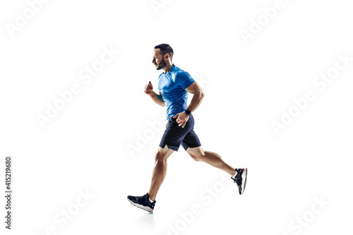 Purpose. Caucasian professional male athlete, runner training isolated on white studio background. Muscular, sportive man. Concept of action, motion, youth, healthy lifestyle. Copyspace for ad.