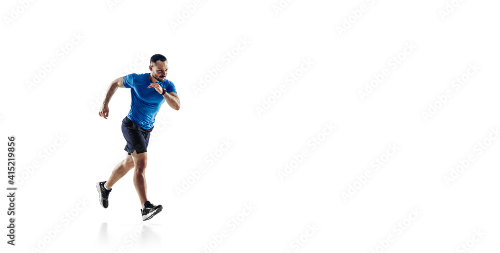 Purpose. Caucasian professional male athlete, runner training isolated on white studio background. Muscular, sportive man. Concept of action, motion, youth, healthy lifestyle. Copyspace for ad. Flyer