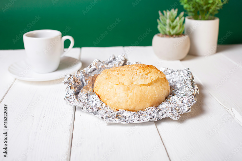 Minimalism, food on a background. Empty text space, mocap. Hot breakfast bun. Green flowers, eco-friendly. Minimalism, food on a background. Empty text space, mocap. Hot breakfast bun. Green flowers, eco-friendly.