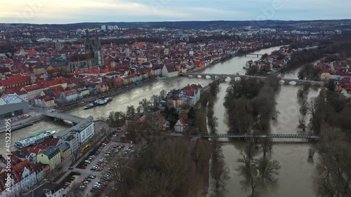 Filmmaterial einer Luftaufnahme mit einer Drohne der Altstadt Regensburg während Hochwasser  mit Dom dem Fluss Donau und steinerne Brücke, Deutschland photo