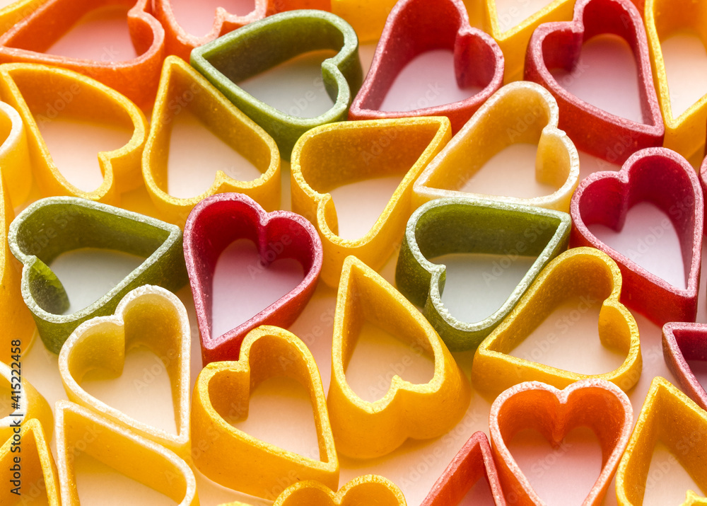 Pasta heart shaped. Italian pasta. Autumn colors. Food for holidays. Love symbol Valentine's Day on white background. Pasta heart shaped. Italian pasta. Autumn colors. Food for holidays. Love symbol Valentine's Day on white background.