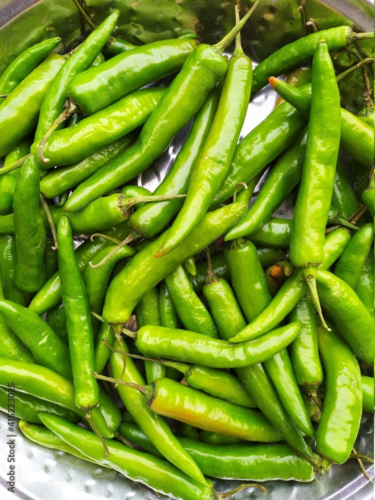 Top view of fresh green serrano pepper as a background