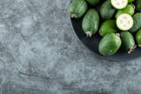 Plate of feijoa fruits on marble background
