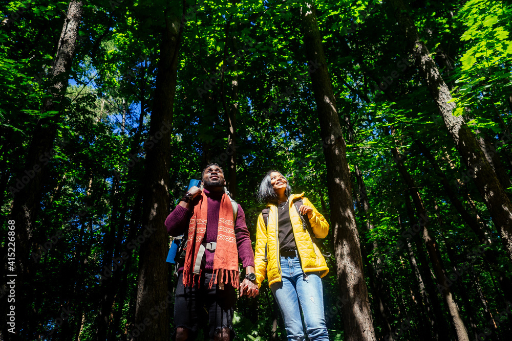 latin american man and hispanic woman in a forest having a rest