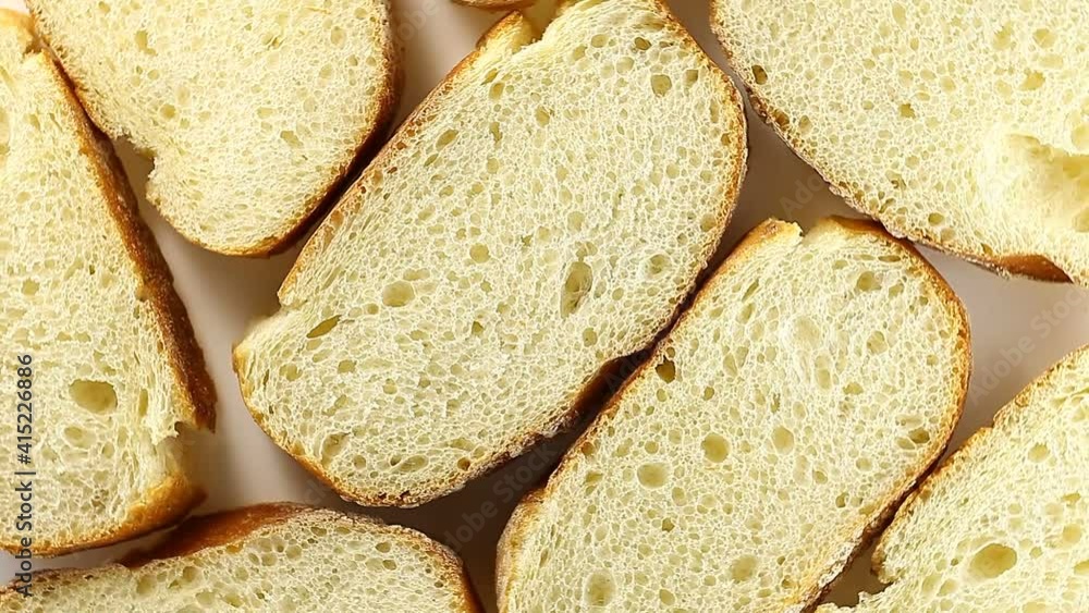 French baguette many cut off pieces rotation, turning clockwise, on white background, top view. French baguette many cut off pieces rotation, turning clockwise, on white background, top view.