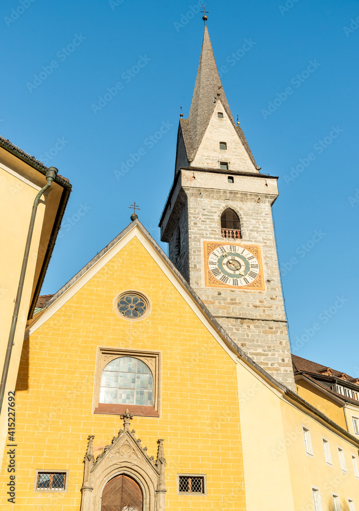 Fototapeta premium Bell tower of the Ursulinen Holy Saviour church in the historic city of Bruneck or Brunico, South Tyrol, Italy